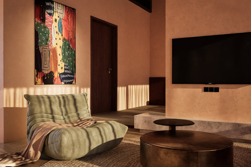 Modern living room with warm lighting, a sage green lounge chair, abstract wall art, and a sleek round coffee table for a cozy ambiance